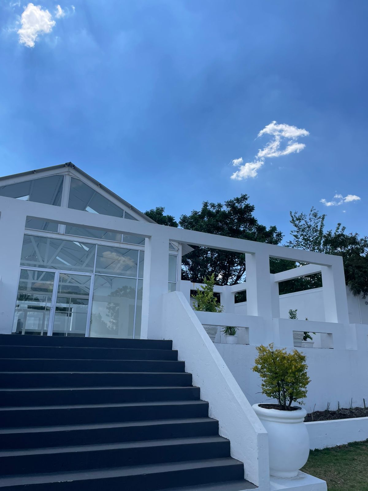 PERE House glass pavilion at the foot of the grand entrance steps